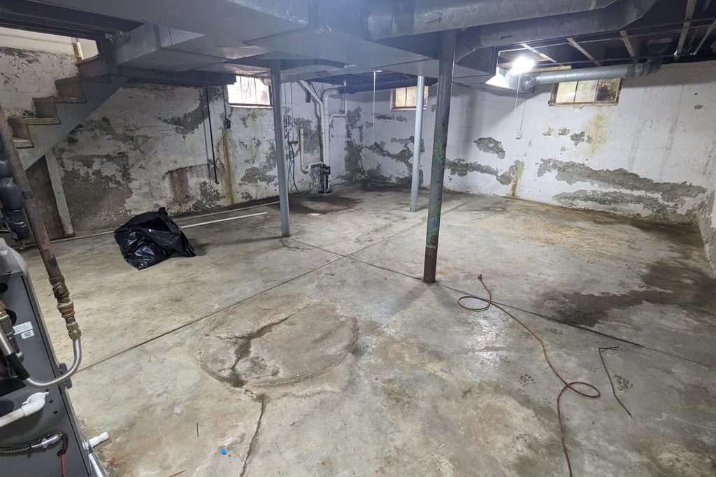 Before: a bare block basement wall