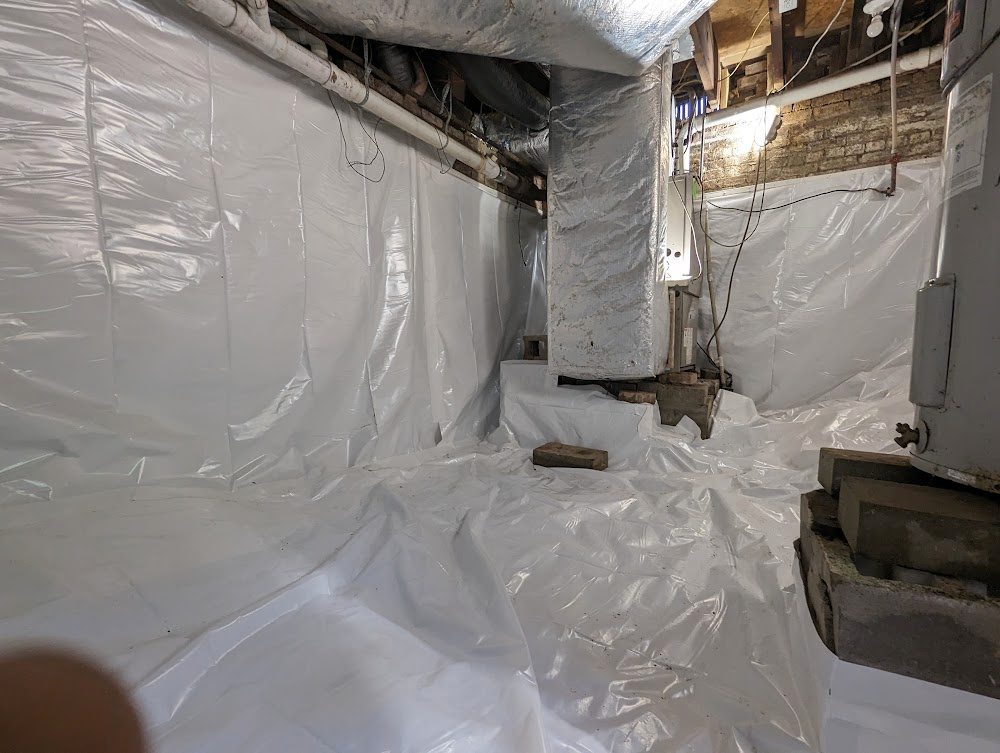 A lined masonry basement corner around the stairs and ducts