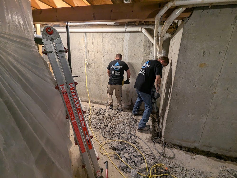 Two workers opening concrete near a corner