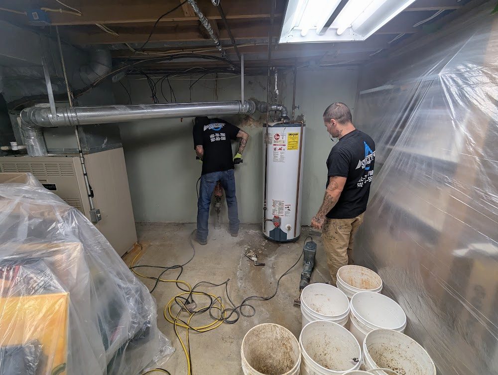 Crew working by the water heater, with plastic sheeting over the room