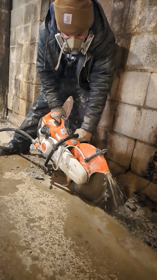 Worker with concrete-cutting saw