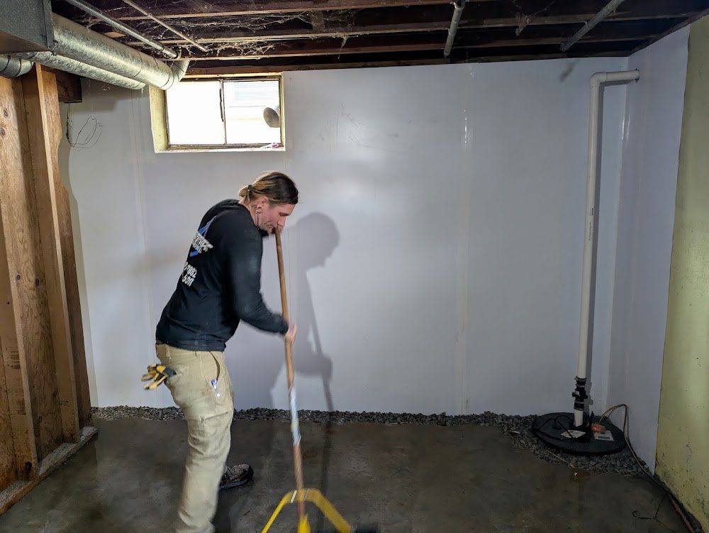 Worker finishing floor edge next to liner and sump
