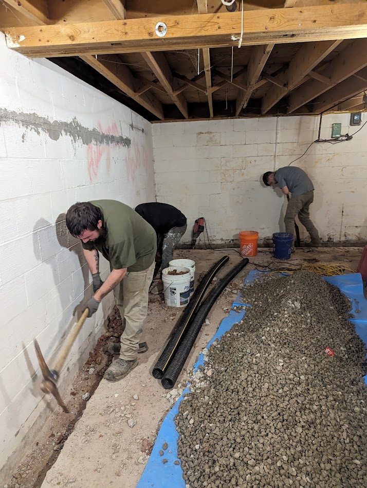 Worker preparing trench beside liner and pipe materials