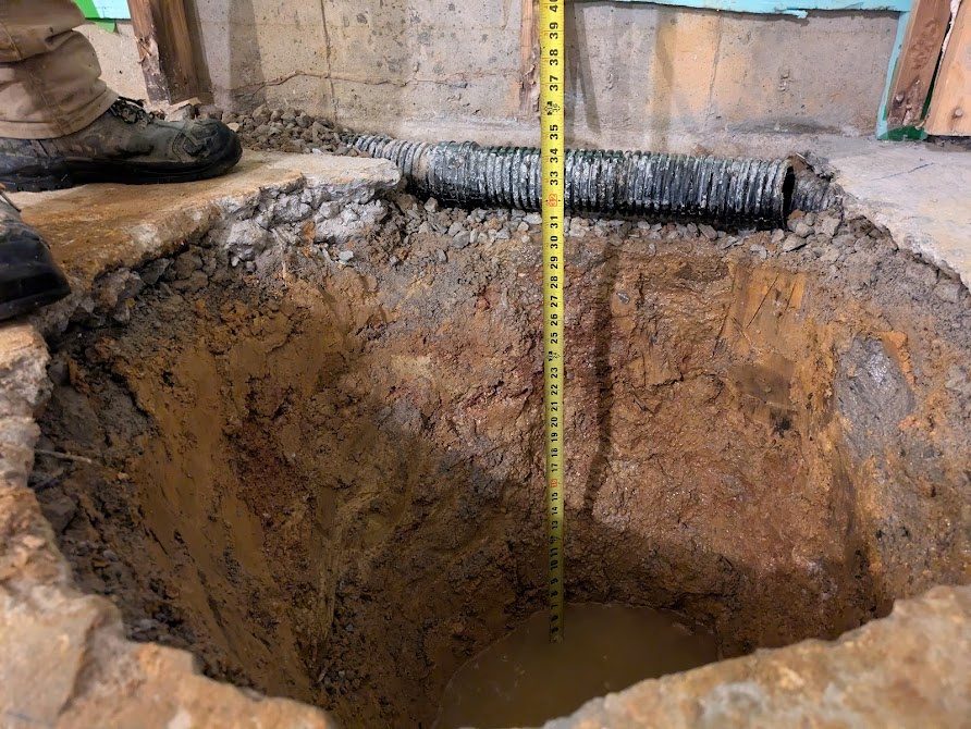 Tape measure over open sump excavation