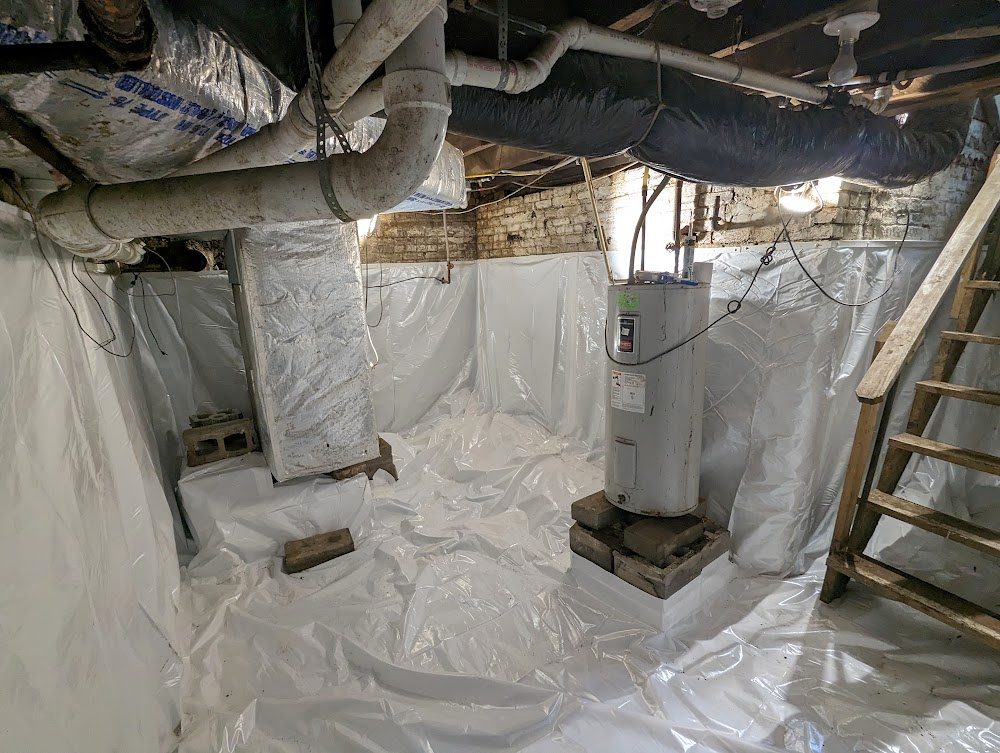 Lined masonry basement around water heater and stairs