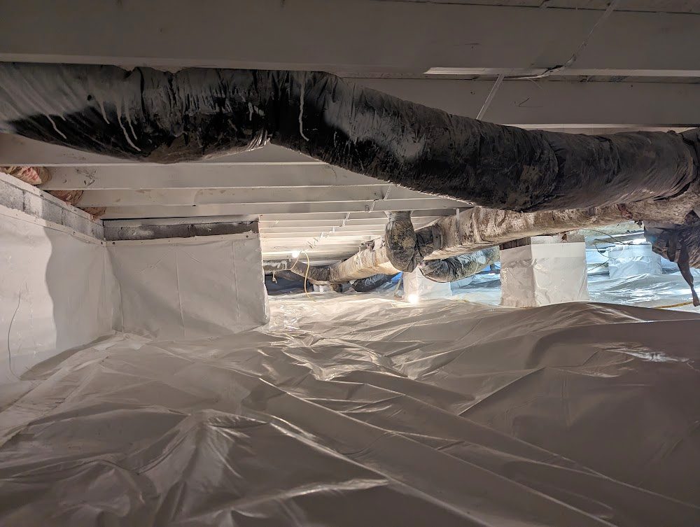 Lined crawl space below a large dark duct