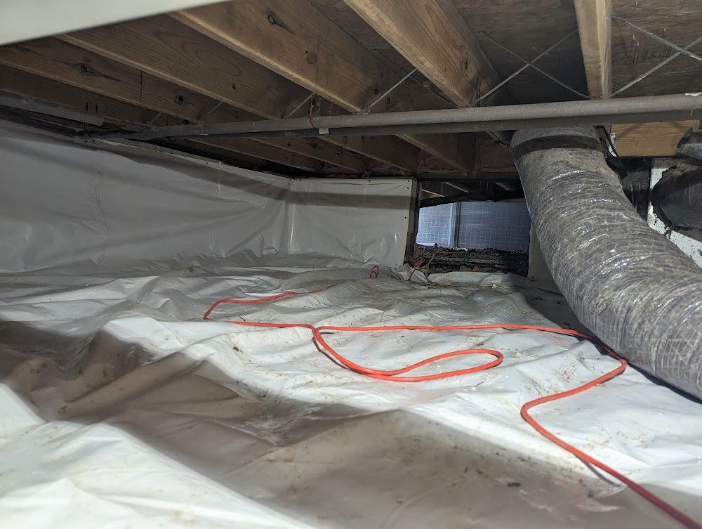 White floor and wall liner with red hose below ductwork