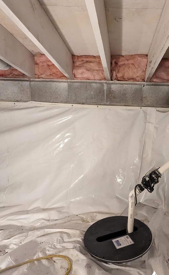 Liner and a sump basin below the joists of a crawl space