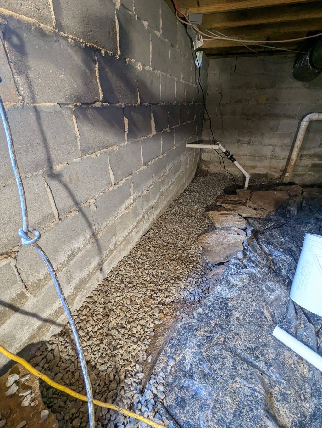 Gravel drainage channel along a crawl space wall
