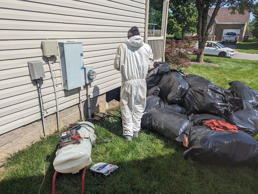 Coverall-clad worker beside bagged material