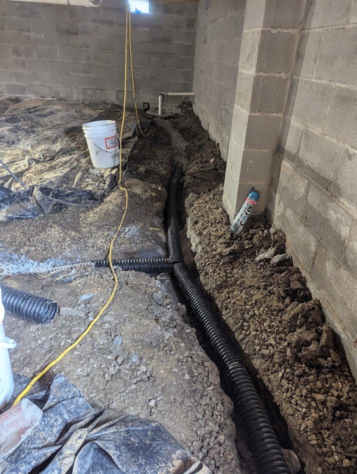 Black pipe along crawl space wall trench