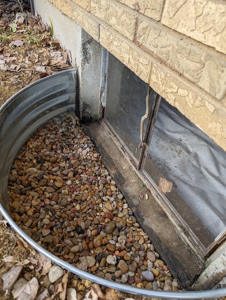 Window well filled with clean gravel