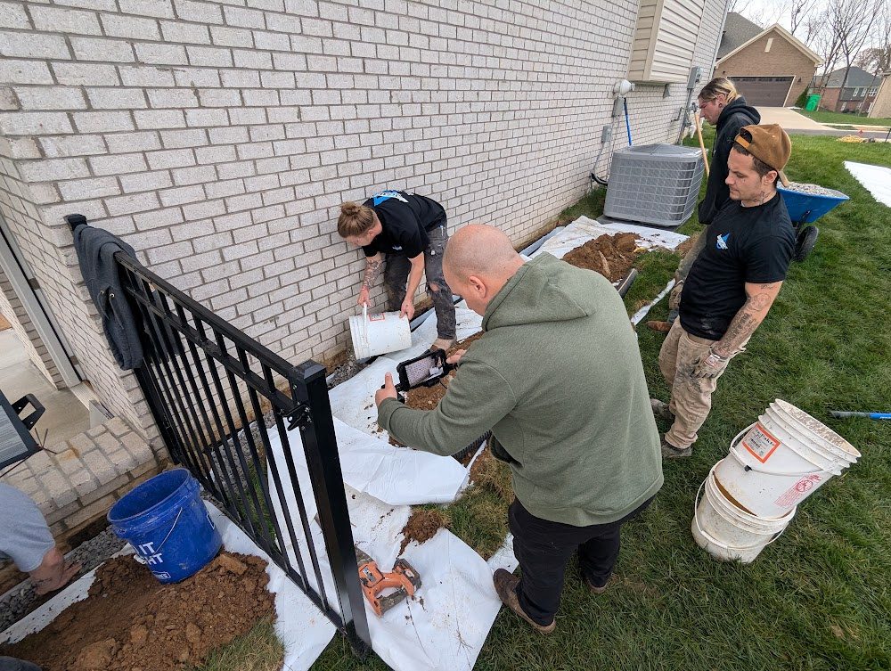 Crew preparing material beside brick house