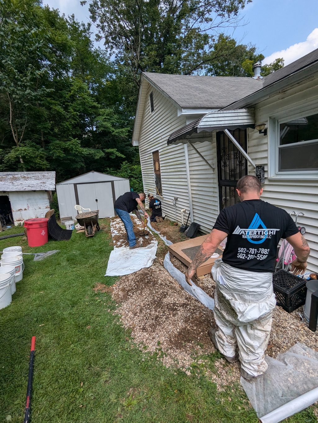Watertight crew beside an excavated trench along a Louisville home