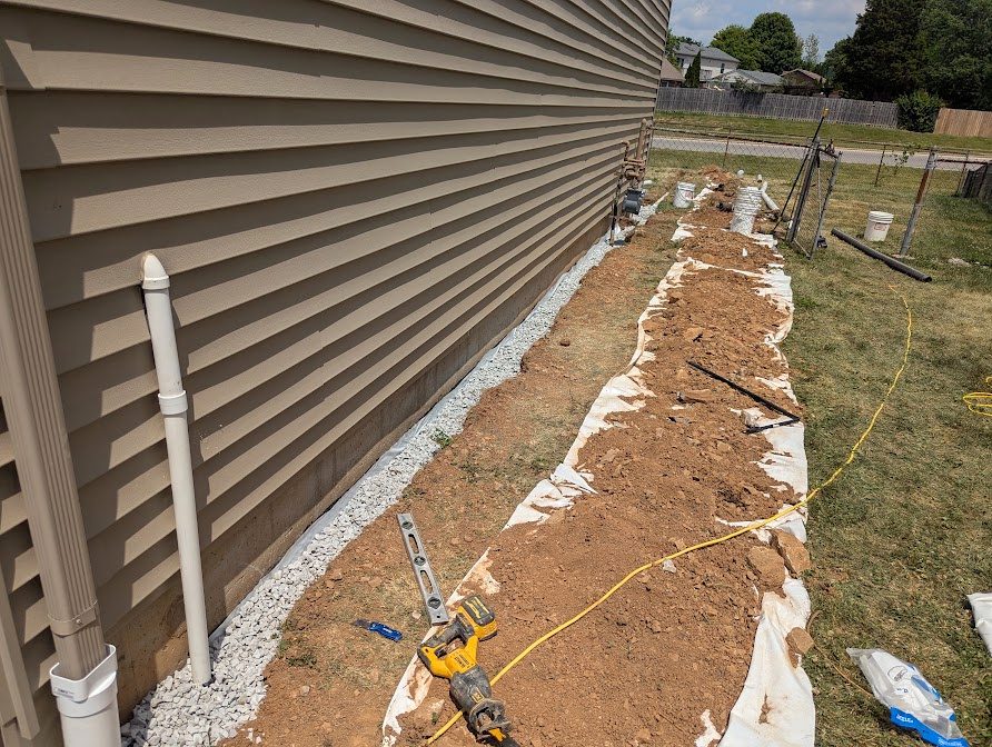 Wide gravel border beside house siding