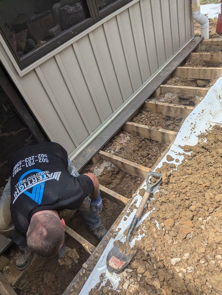 Worker in exterior framing trench