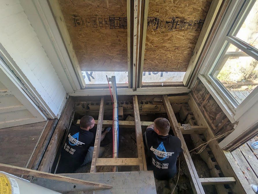 Two workers in an opened interior floor
