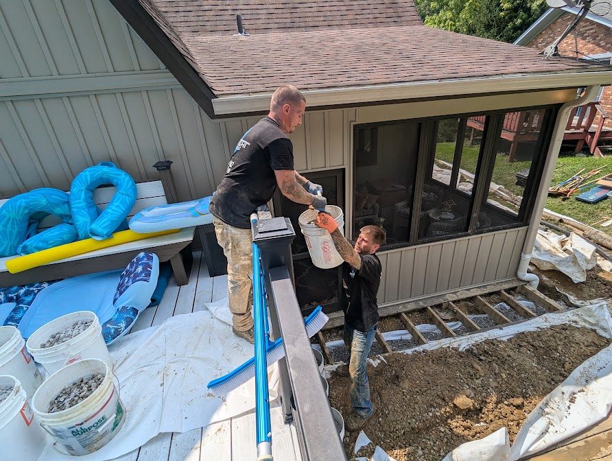 Watertight workers beside opened exterior framing