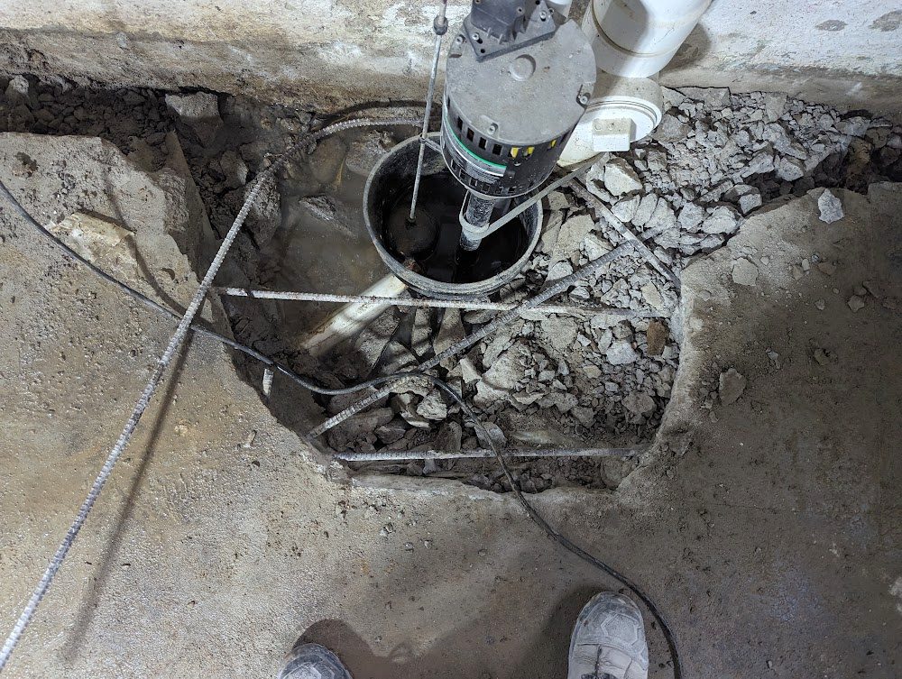 Looking down at a pump and cables in an open floor